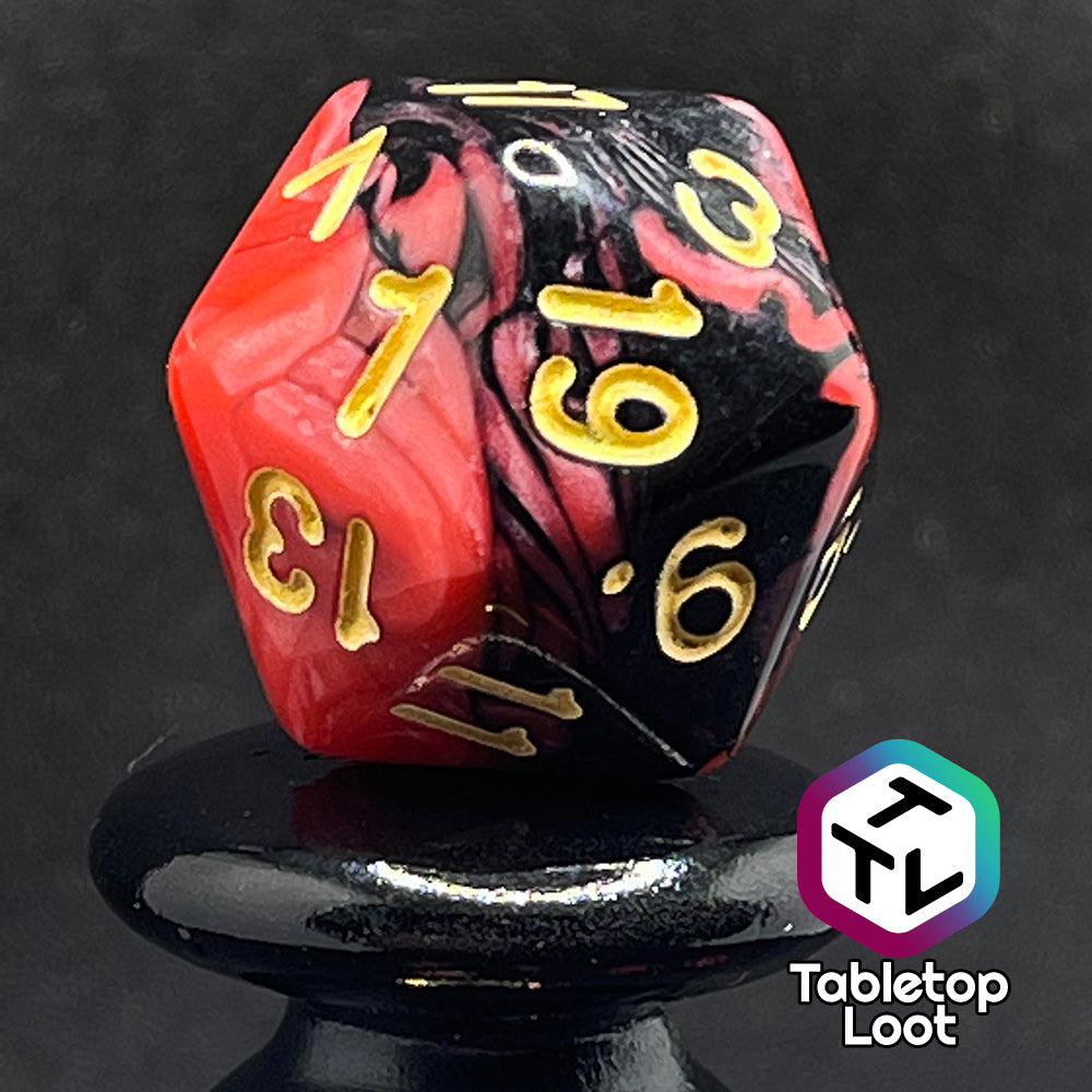 A close up of the D20 from the Forge Embers 7 piece dice set with swirled black and red and gold numbering.