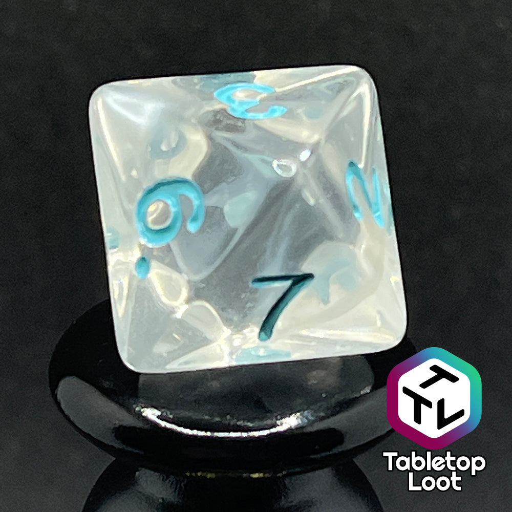 A close up of the D8 from the Frostmaiden 7 piece dice set from Tabletop Loot with swirls of frosty white in clear resin and blue numbering.