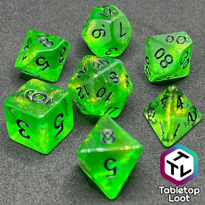 The Gelatinous Cube 7 piece dice set from Tabletop Loot; lime green with gold shimmer and black numbering.