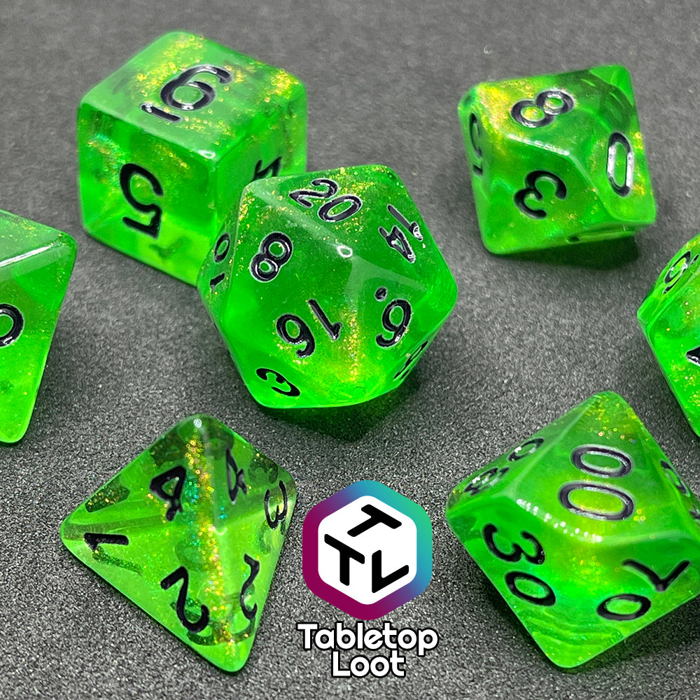 The Gelatinous Cube 7 piece dice set from Tabletop Loot; lime green with gold shimmer and black numbering.