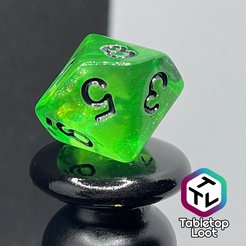 A close up of the D10 from the Gelatinous Cube 7 piece dice set from Tabletop Loot; lime green with gold shimmer and black numbering.