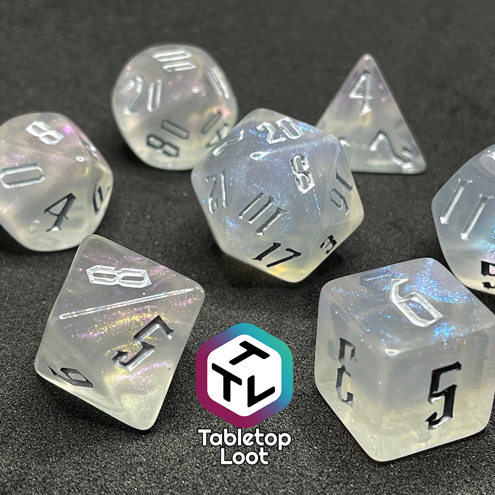 7 piece translucent polyhedral dice set with iridescent micro-glitter and silver numbers.