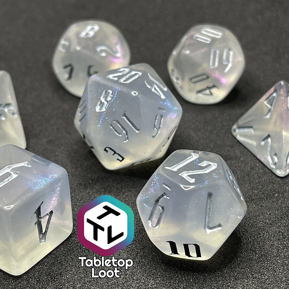 7 piece translucent polyhedral dice set with iridescent micro-glitter and silver numbers.