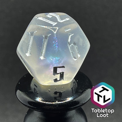 Translucent d12 with iridescent micro-glitter and silver numbers.