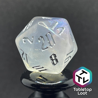 Translucent d20 with iridescent micro-glitter and silver numbers.