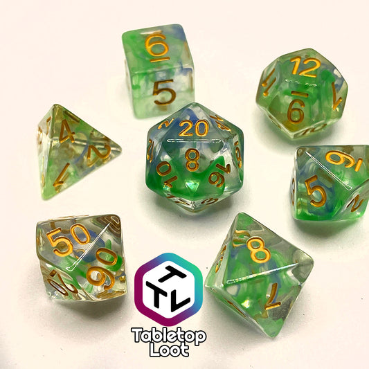 The Gentle Repose 7 piece dice set with swirls of bright green and blue in clear resin and gold numbering.