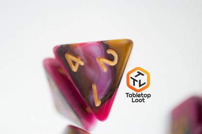 A close up of the D4 from the GoodBerries 7 piece dice set from Tabletop Loot with swirls of red, brown, black, and white and gold numbering.