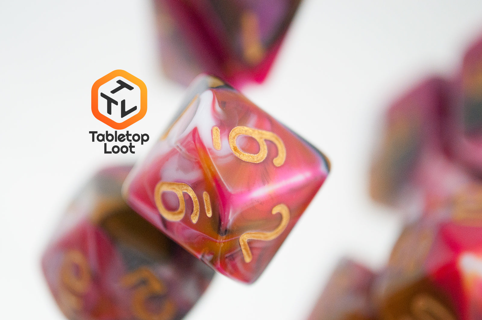 A close up of the D10 from the GoodBerries 7 piece dice set from Tabletop Loot with swirls of red, brown, black, and white and gold numbering.