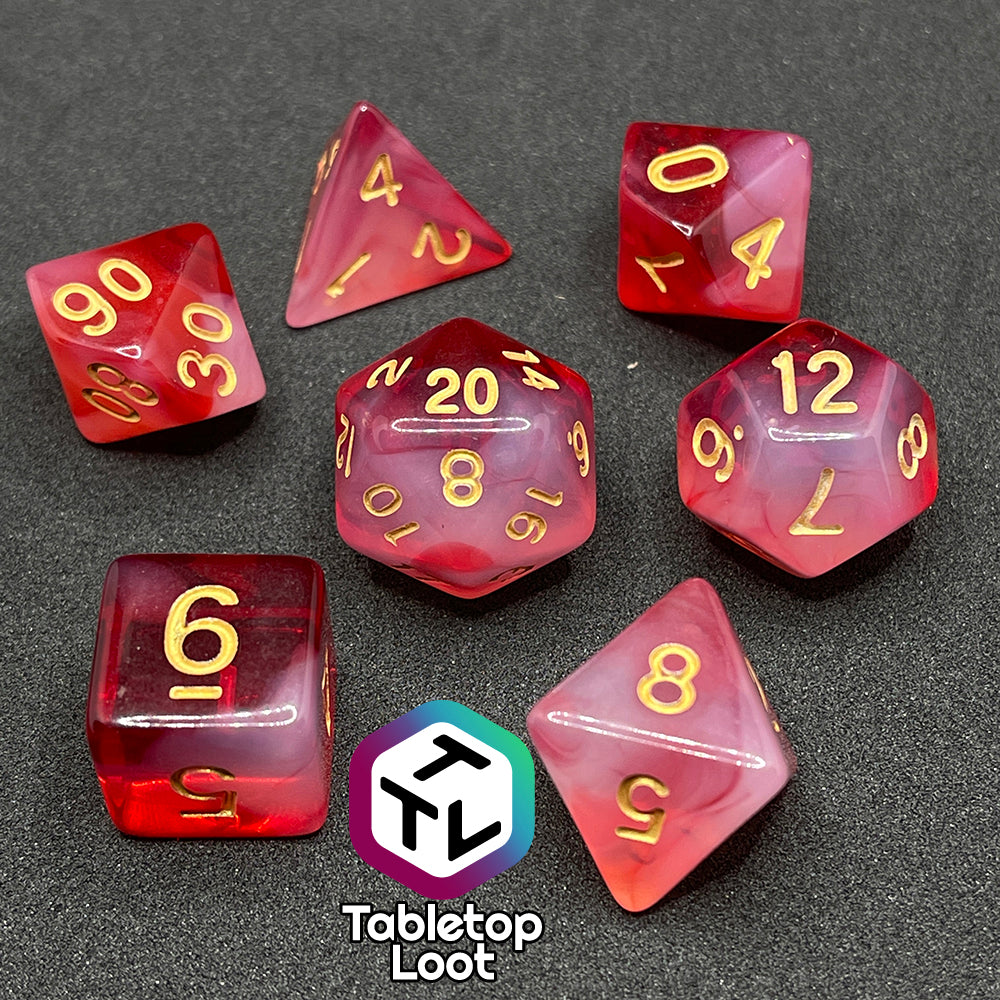 The Healing Word 7 piece dice set from Tabletop Loot with swirls of white in red and gold numbering.