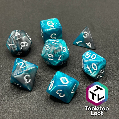 The Hunter's Mark 7 piece dice set from Tabletop Loot with pearlescent swirls of blue and silver and white numbering.