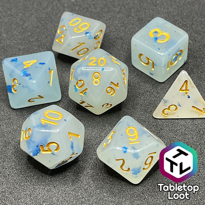 The Ice Shards 7 piece dice set from Tabletop Loot with blue metal flakes in milky white resin with gold numbering.