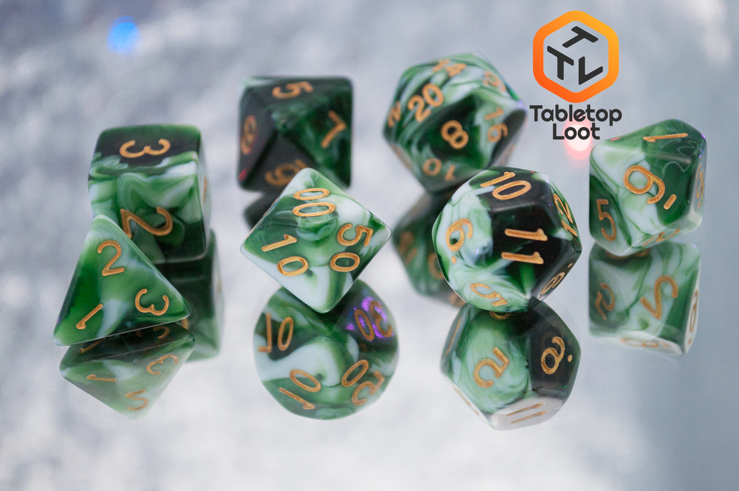 The Jadeite Cabbage 7 piece dice set from Tabletop Loot with swirls of shades of green and white, numbered in gold.