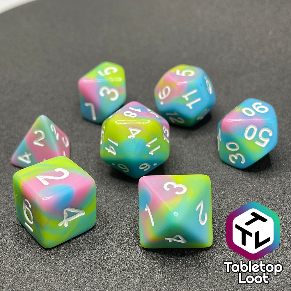 The Jawbreakers 7 piece dice set from Tabletop Loot with swirls of pink, blue, and green and white numbers.