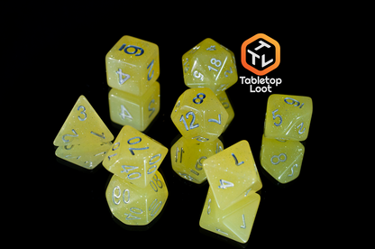 The Lemon Drops 7 piece dice set from Tabletop Loot; bright yellow with silver glitter and numbering.