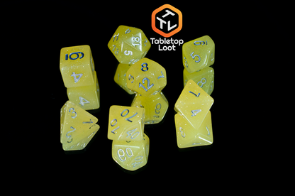 The Lemon Drops 7 piece dice set from Tabletop Loot; bright yellow with silver glitter and numbering.