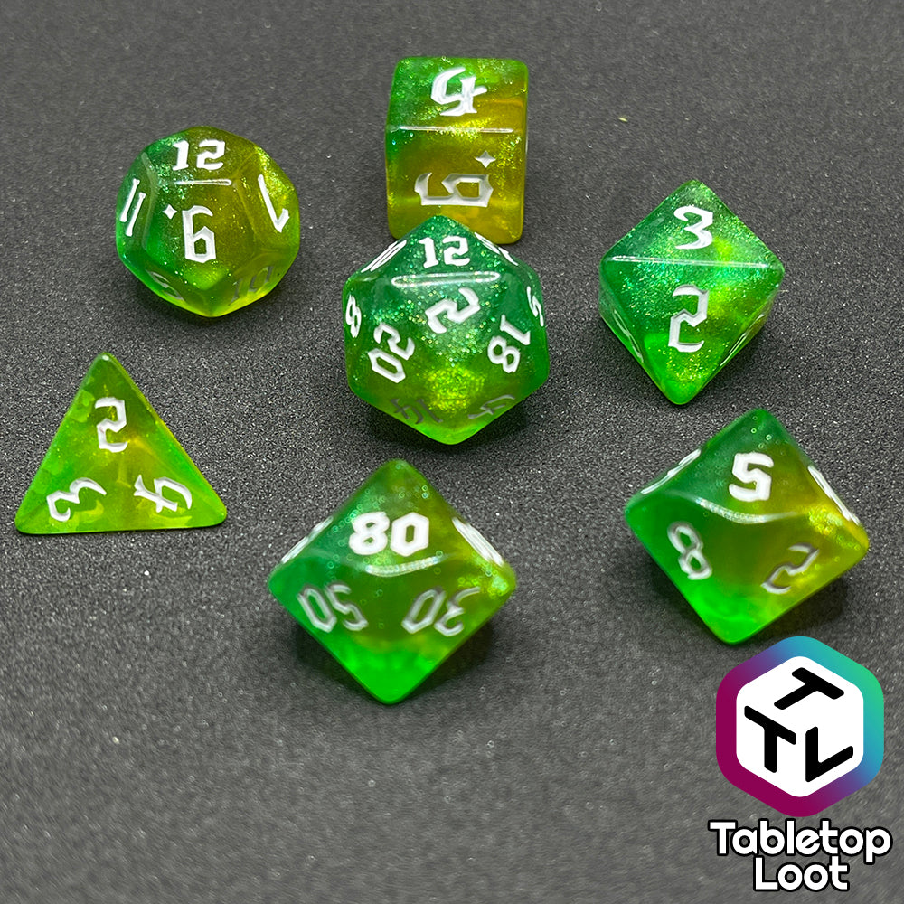 The Luck 7 piece dice set from Tabletop Loot; translucent green and yellow swirled with micro glitter and white gothic numbering.