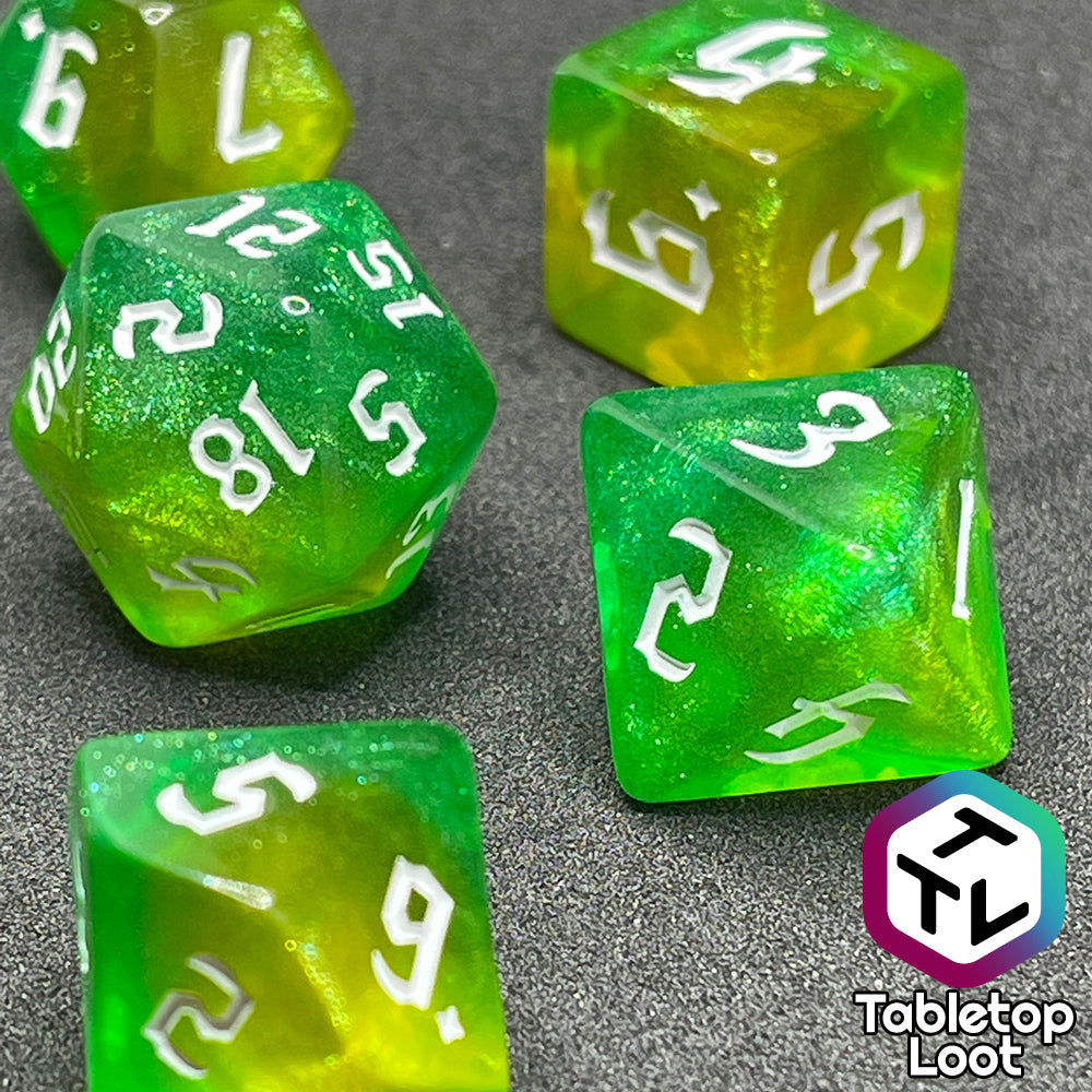 A close up of the D8 and D20 from the Luck 7 piece dice set from Tabletop Loot; translucent green and yellow swirled with micro glitter and white gothic numbering.
