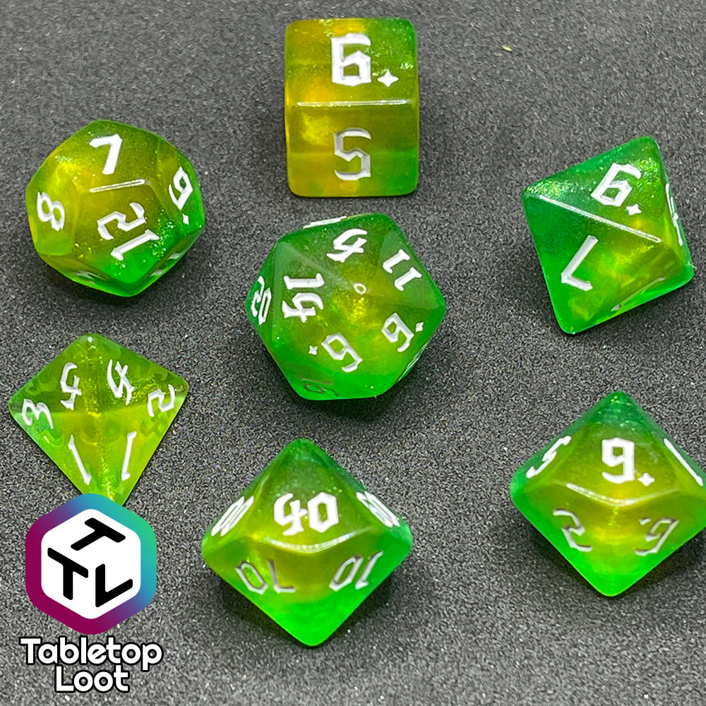 The Luck 7 piece dice set from Tabletop Loot; translucent green and yellow swirled with micro glitter and white gothic numbering.