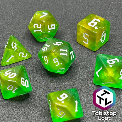 The Luck 7 piece dice set from Tabletop Loot; translucent green and yellow swirled with micro glitter and white gothic numbering.