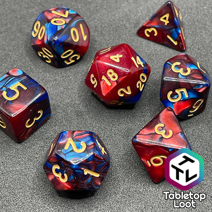 The Metropolis 7 piece dice set with swirls of pearlescent blue and red and gold numbering.