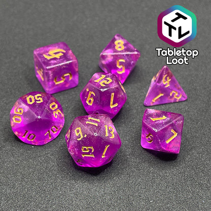 The Moxie 7 piece dice set from Tabletop Loot; fuchsia dice packed with glitter and gold gothic numbering.