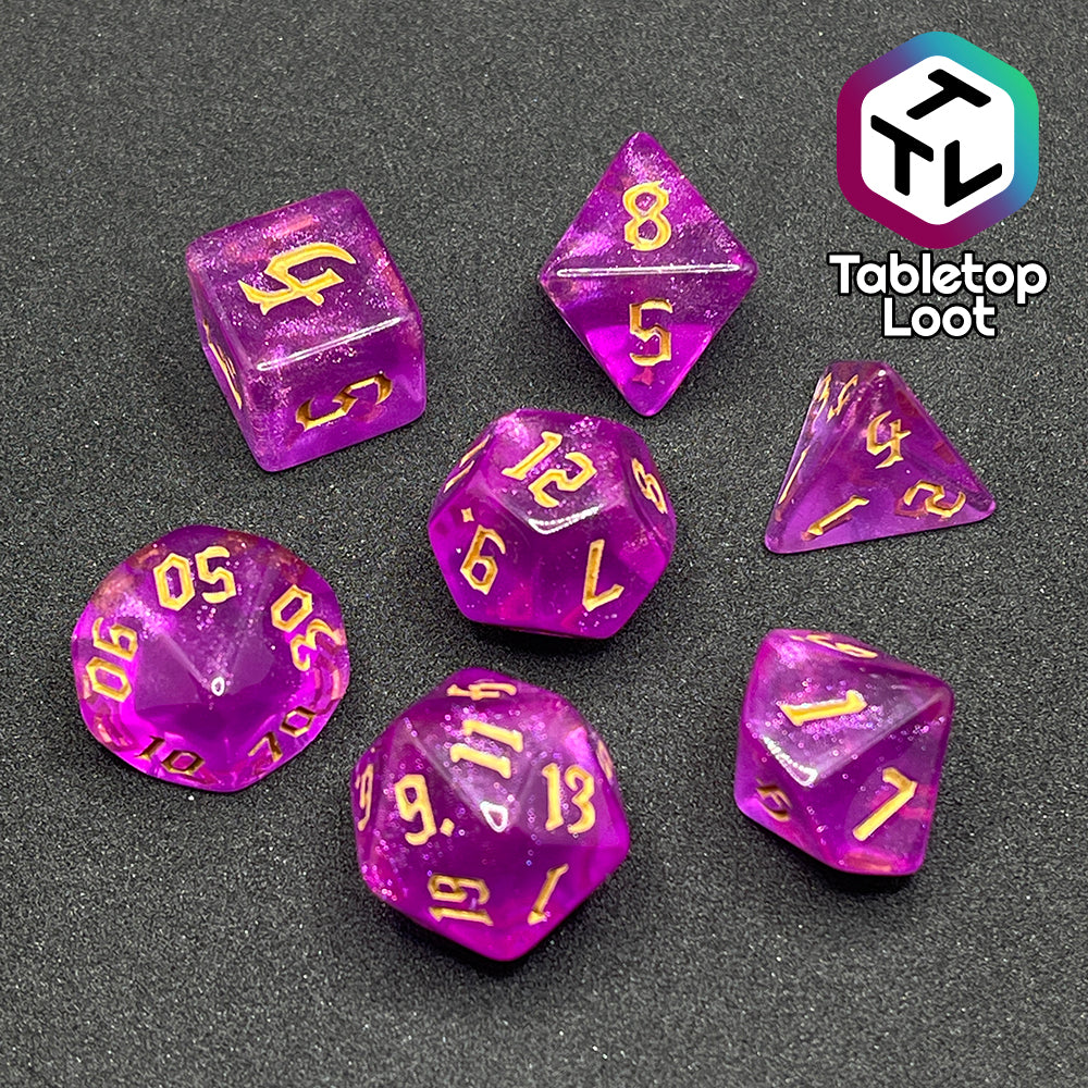 The Moxie 7 piece dice set from Tabletop Loot; fuchsia dice packed with glitter and gold gothic numbering.