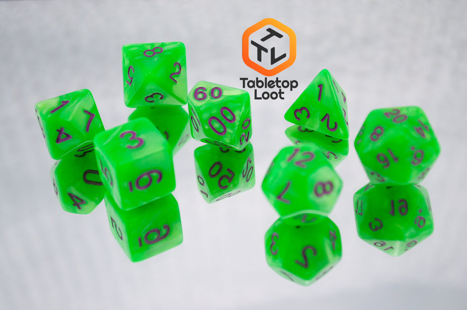 The Radioactive Green 7 piece dice set from Tabletop Loot with bright green resin and purple numbering.