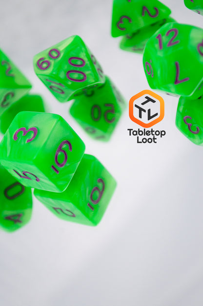 The Radioactive Green 7 piece dice set from Tabletop Loot with bright green resin and purple numbering.