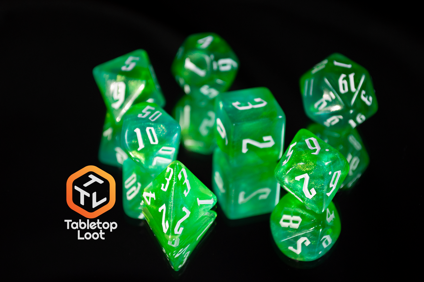 The Nature's Fury 7 piece dice set from Tabletop Loot with shimmering translucent green resin and white numbering.