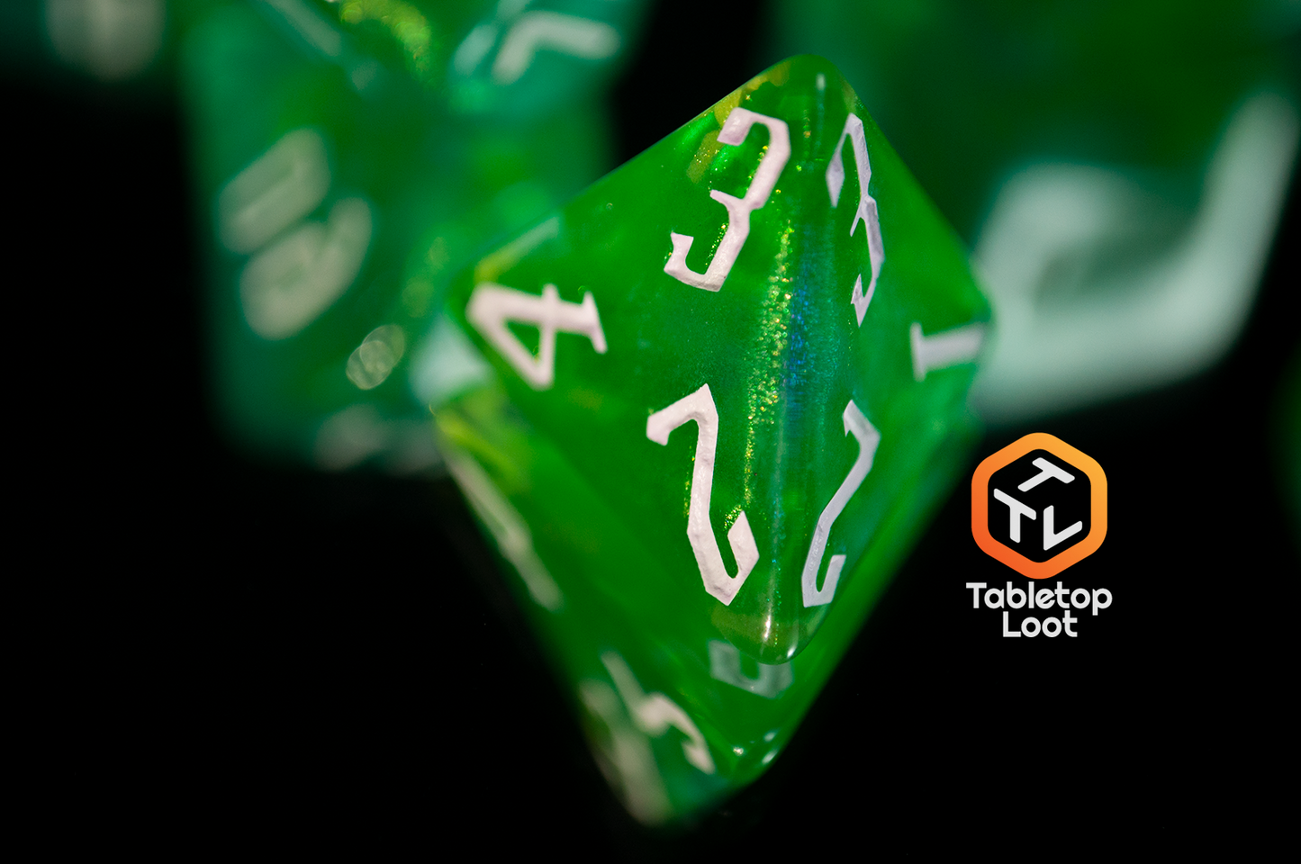 A close up of the D4 from the Nature's Fury 7 piece dice set from Tabletop Loot with shimmering translucent green resin and white numbering.