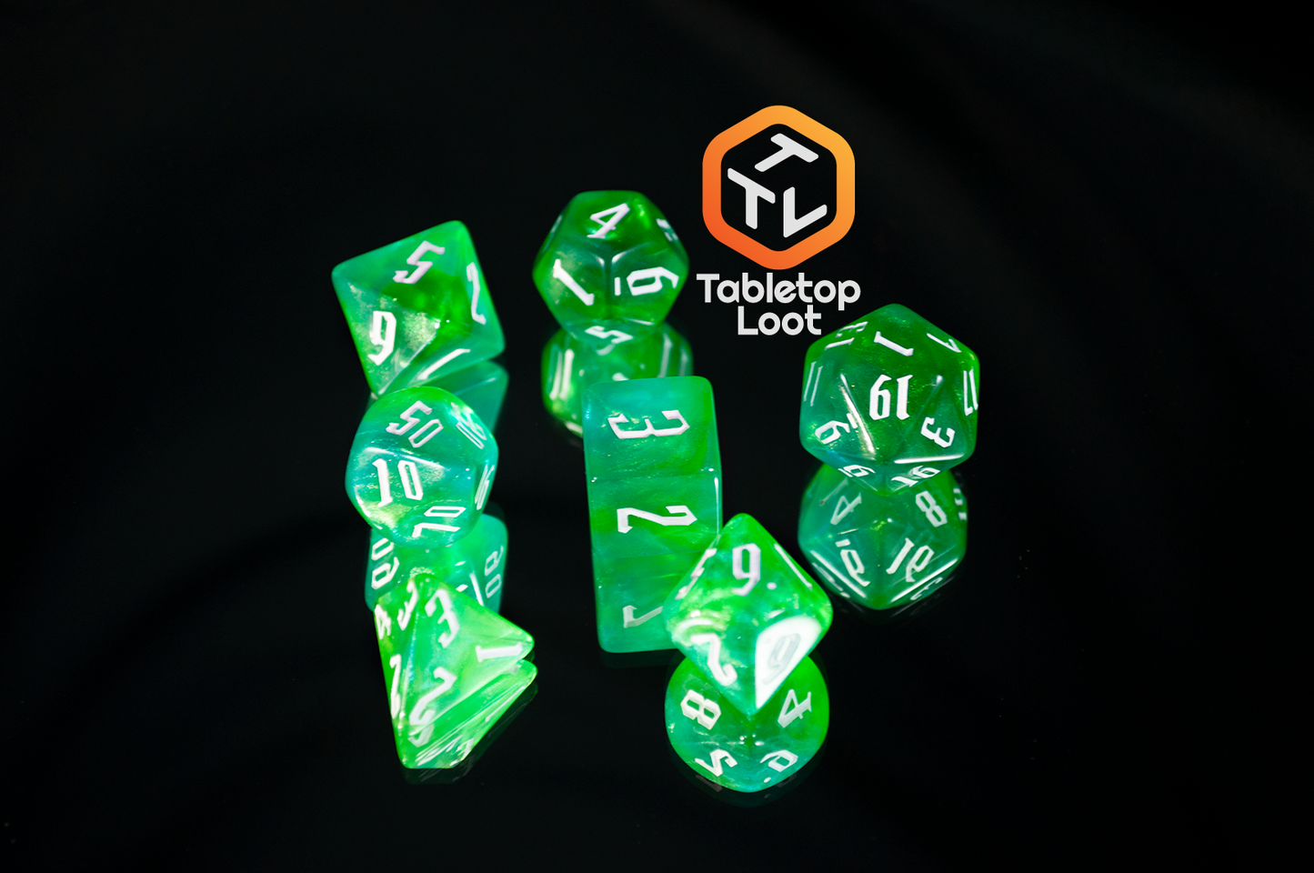 The Nature's Fury 7 piece dice set from Tabletop Loot with shimmering translucent green resin and white numbering.