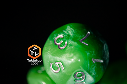 A close up of the Necropolis D10 from Tabletop Loot to show the intense shimmer and variation of green in the layers.