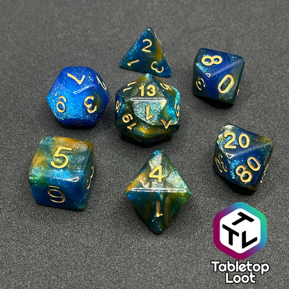 The Nimrodel 7 piece dice set from Tabletop Loot with swirls of glittering blue, green, and orange and golden numbering.