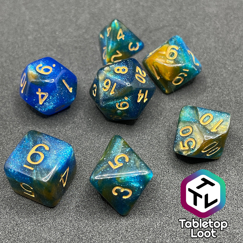 The Nimrodel 7 piece dice set from Tabletop Loot with swirls of glittering blue, green, and orange and golden numbering.
