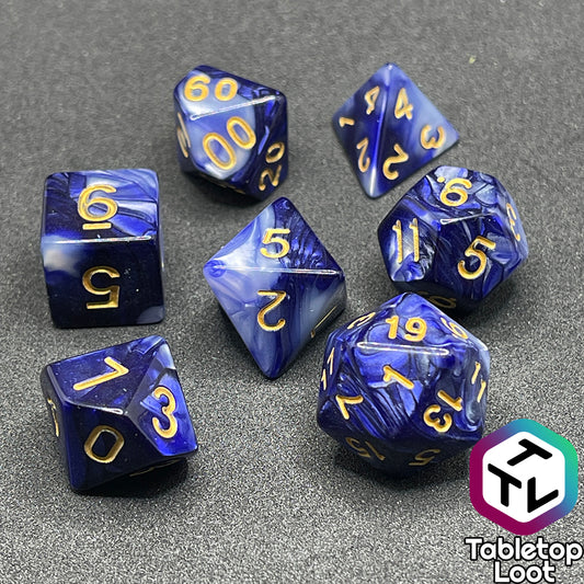 The Order of the Night's Veil 7 piece dice set from Tabletop Loot with swirls of pearlescent purple and white with gold numbering.