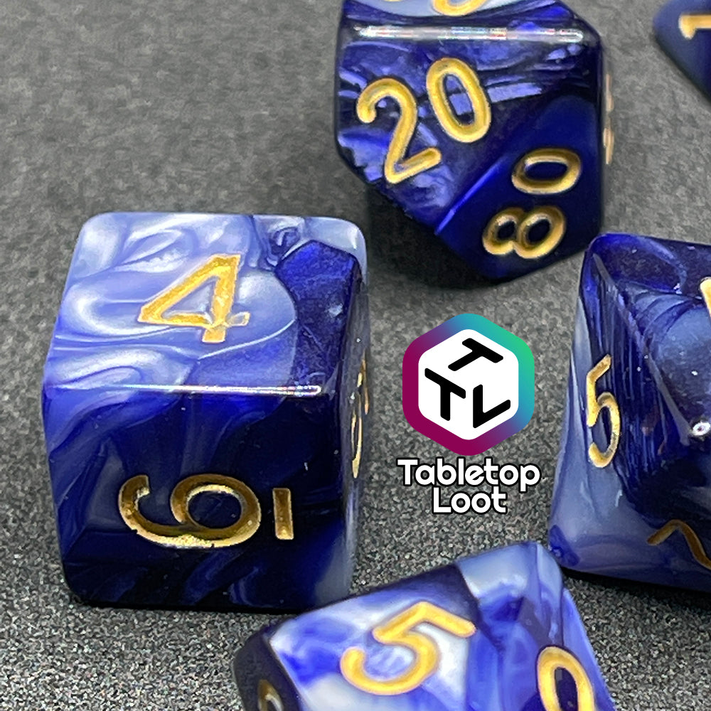 A close up of the D6 from the Order of the Night's Veil 7 piece dice set from Tabletop Loot with swirls of pearlescent purple and white with gold numbering.