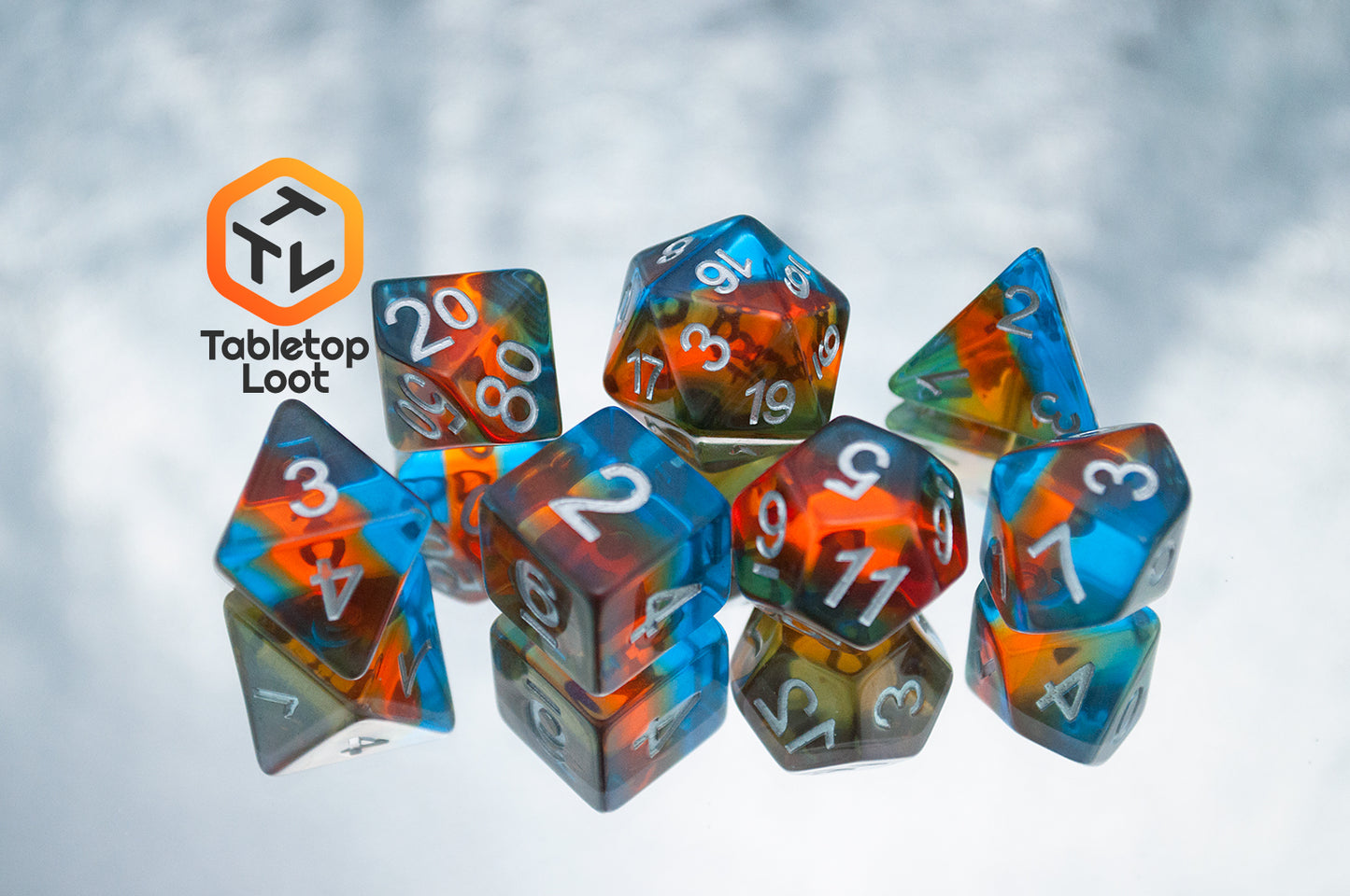 The Parallel Universes 7 piece dice set from Tabletop Loot with an orange stripe in blue resin and silver numbering.