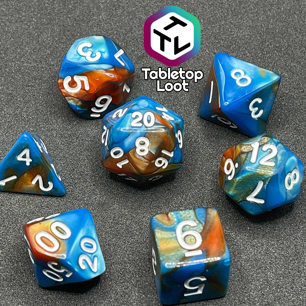 A close up of the Patina Copper 7 piece dice set from Tabletop Loot with swirls of pearlescent blue and orange and white numbering.