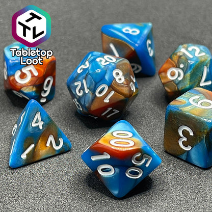 A close up of the Patina Copper 7 piece dice set from Tabletop Loot with swirls of pearlescent blue and orange and white numbering.