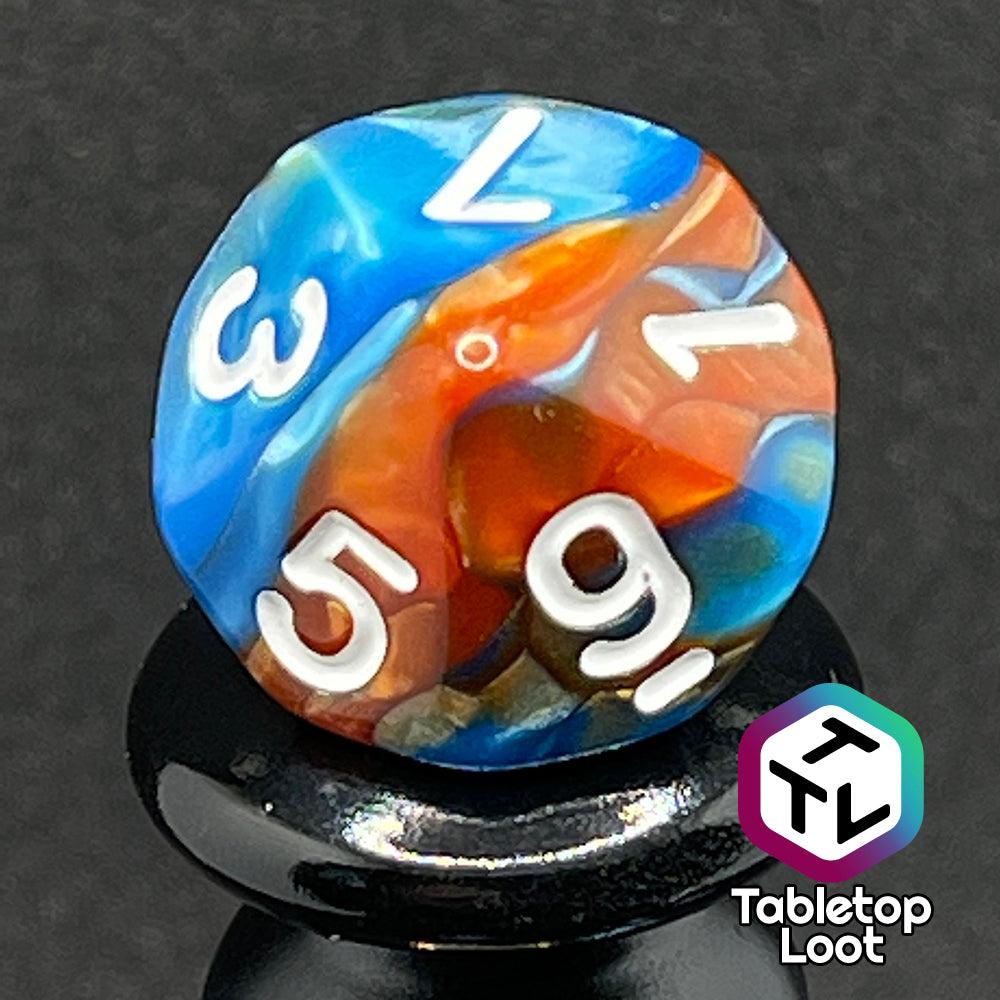 A close up of the D10 from the Patina Copper 7 piece dice set from Tabletop Loot with swirls of pearlescent blue and orange and white numbering.