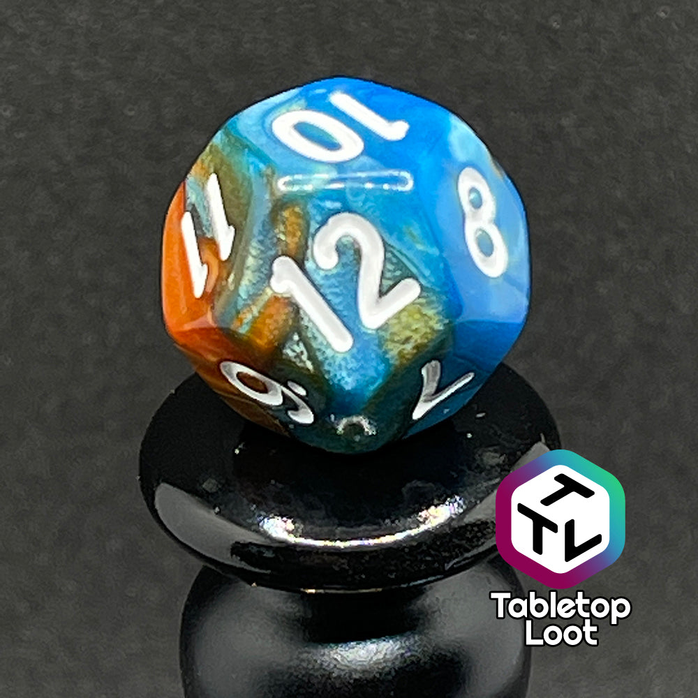 A close up of the D12 from the Patina Copper 7 piece dice set from Tabletop Loot with swirls of pearlescent blue and orange and white numbering.