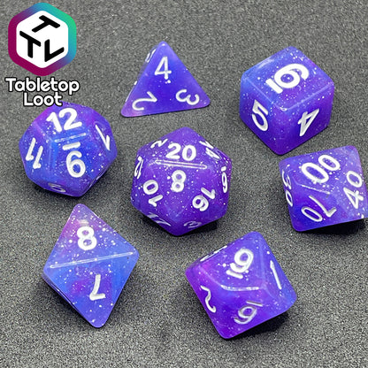 The Phantasmal Force 7 piece dice set with swirls of blue and purple, lots of glitter, and white numbering.