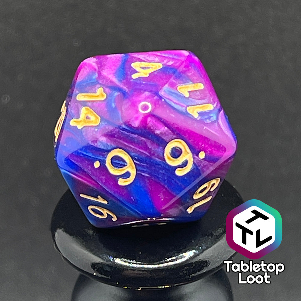 A close up of the D20 from the Spelljammin' 7 piece dice set from Tabletop Loot with pearlescent swirls of purple and blue and gold numbering.