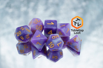 The Purple Jade 7 piece dice set from Tabletop Loot with swirled purple and white resin and gold numbering.