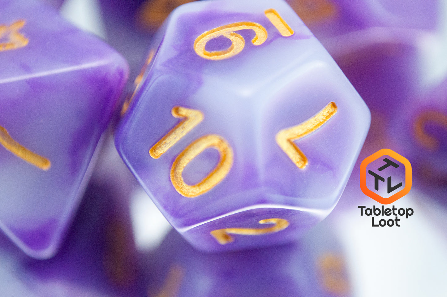 A close up of the D12 from the Purple Jade 7 piece dice set from Tabletop Loot with swirled purple and white resin and gold numbering.