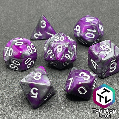 The Purple Knight 7 piece dice set from Tabletop Loot with swirls of purple and pearlescent grey and white numbering.