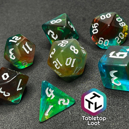 Set of seven semi-translucent dice swirling with blues, greens, reds, & yellows with white numbers.