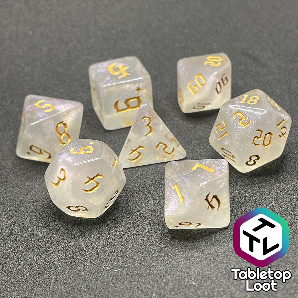 The Revivify 7 piece dice set from Tabletop Loot; semi-translucent dice with iridescent micro glitter and gold gothic numbering.