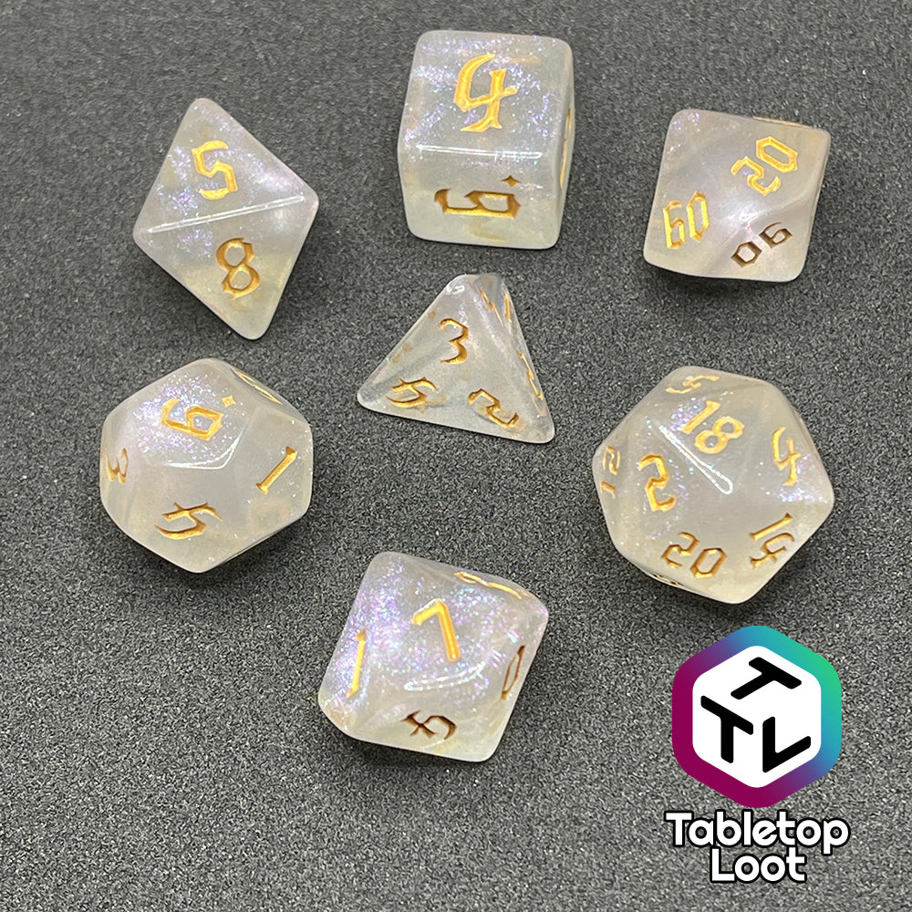 The Revivify 7 piece dice set from Tabletop Loot; semi-translucent dice with iridescent micro glitter and gold gothic numbering.