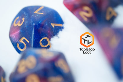 A close up of the D10 from the Rose Galaxy 7 piece dice set from Tabletop Loot with swirls of glittery pink, purple, and blue throughout with gold numbering.